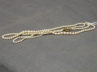 A rope of pearls with 15ct gold clasp and 1 other