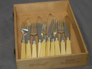 A set of 5 silver plated fish knives and forks with carved ivory handles