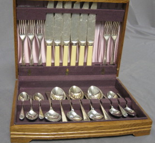 A canteen of Old English pattern chromium plated cutlery, contained in an oak box