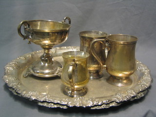 A silver plated twin handled cup 6", 2 circular embossed silver platters 17", a hotelware twin handled tureen and 3 silver plated tankards