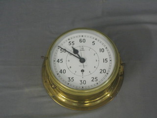 A ward room clock, the 8" painted plastic dial marked in 1-12 and 5-60 with broad arrow and number to the centre 0552/160174