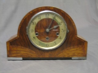 A 1930's chiming mantel clock with silvered dial and chapter ring contained in an arched walnut case