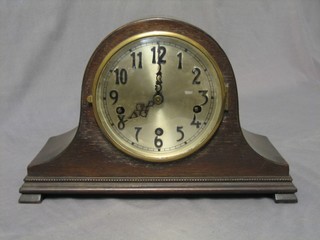 A chiming mantel clock with silvered dial and Arabic numerals contained in an oak Admirals hat shaped case