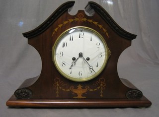An Edwardian French 8 day striking mantel clock with enamelled dial and Roman numerals contained in an inlaid mahogany shaped case