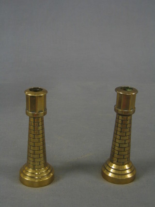 A pair of 19th Century heavy turned brass candlesticks in the form of light houses 6"
