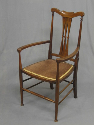 An Edwardian Art Nouveau inlaid mahogany open arm chair, raised on turned supports