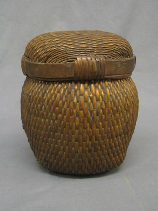 An Eastern circular wicker work basket and cover