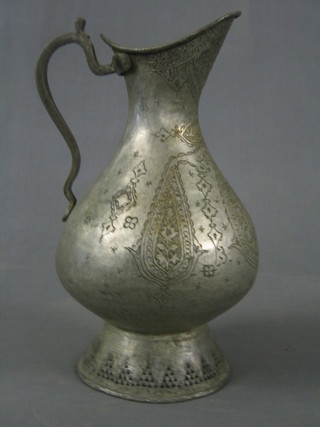 An Eastern engraved metal baluster shaped jug 15"