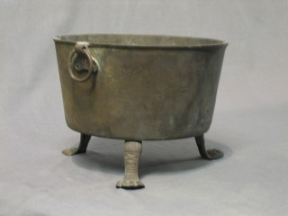A circular brass twin handled brass planter raised on iron feet 10" (some old repairs)