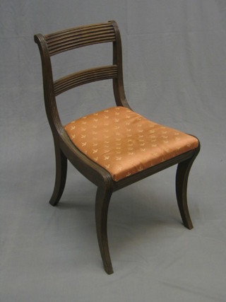A Regency mahogany bar back chair with shaped mid rail, woven cane back and upholstered drop in seat