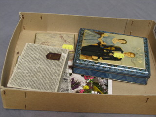 A metal tin decorated The Queen and Prince Phillip containing various envelopes addressed to Princess Elizabeth etc, a small collection of postcards, greetings cards, silk cards and playing cards