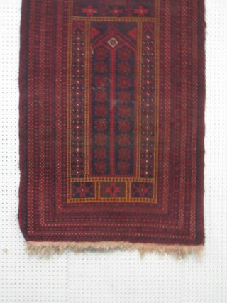 A contemporary red ground Belouche rug 57" x 33"