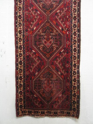 A contemporary Persian Shiraz red ground runner with 3 octagons to the centre 118" x 41"