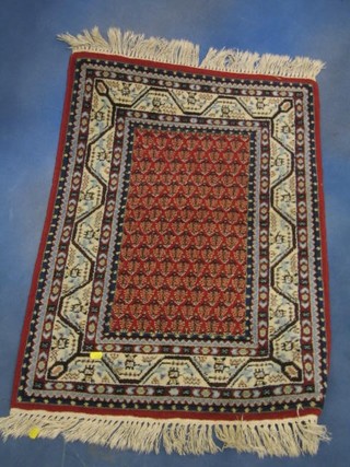 A fine quality  contemporary blue and red ground Persian rug with Paisley design to the centre,  35" x 24"