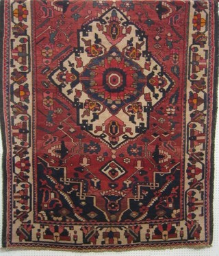 A contemporary Bakhtiari blue and red ground rug with central medallion 93" x 62"