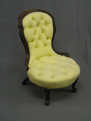A Victorian carved walnut show frame spoon back nursing chair, raised on cabriole supports upholstered in yellow material (old break to back and missing carved crest to front cabriole supports)
