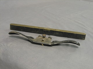A brass and ebony spirit level by E Preston & Sons together with a spoke shave