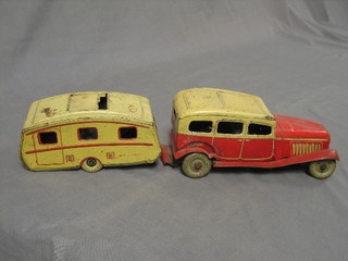 A 1940/50's tin plate clock work model of a 2 tone red and yellow car with Dunlop metal tyres, (radiator f) together with a matching caravan, marked Made in England TMC 9596