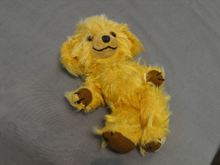 A Merrythorpe figure of a yellow teddybear, head fitted a bell 9"