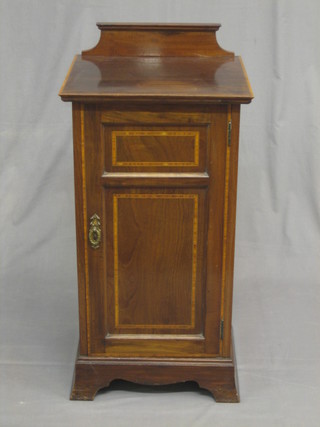 An Edwardian inlaid mahogany pot cupboard enclosed by a panelled door 16 1/2"