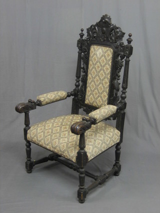 A Victorian Carolean style carved oak armchair with upholstered seat and back, raised on turned and block supports