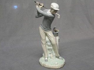 A Lladro figure of a standing golfer with iron, base impressed D-4N, 11"