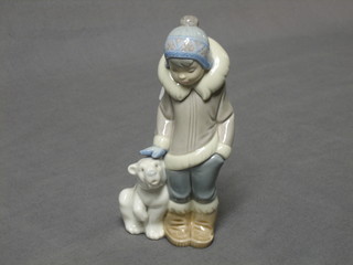 A Lladro figure of a standing Eskimo with baby polar bear, 6"