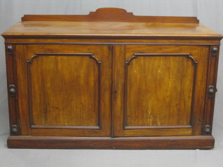 A Victorian mahogany sideboard/leaf bearer enclosed by panelled doors, raised on a platform base 65"