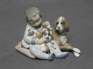 A Lladro figure Mis Amigos, boy with seated dogs, base marked 5456 5"