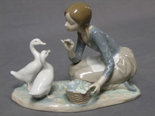 A Lladro figure group of a girl feeding 2 geese, base marked 19E 7"