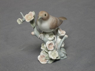 A Lladro figure of a bird on a branch, base marked 17 4"