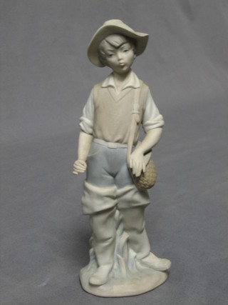 A  Lladro biscuit porcelain figure of a young fisherman, base marked 5, 9"