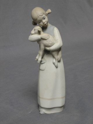 A Lladro biscuit porcelain figure of a standing young shepherdess 9"