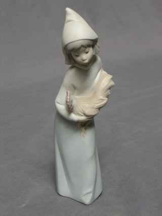 A Lladro biscuit porcelain figure of a standing girl with chicken 8"