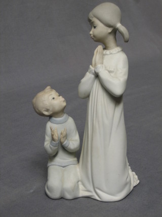 A Lladro biscuit porcelain figure of 2 praying children, base marked 3, 9"
