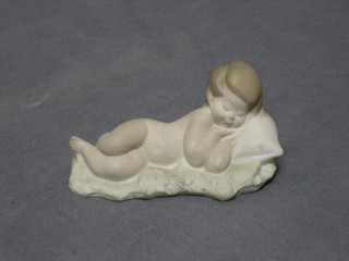 A Lladro biscuit porcelain figure of a reclining baby 4"