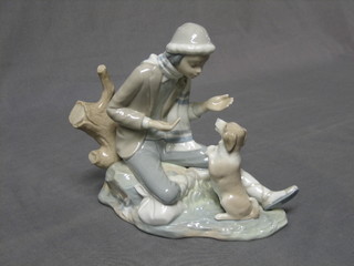 A Nao figure of a seated boy with dog, base marked Nao 2, 8"