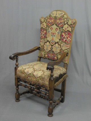 A handsome 17th/18th Century Continental carved walnut high back chair on bobbin turned supports, the seat and back upholstered in tapestry