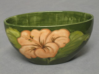 A "Moorcroft" boat shaped vase decorated coral Hibiscus against a green ground, the base with Potter to Queen label 6 1/2"