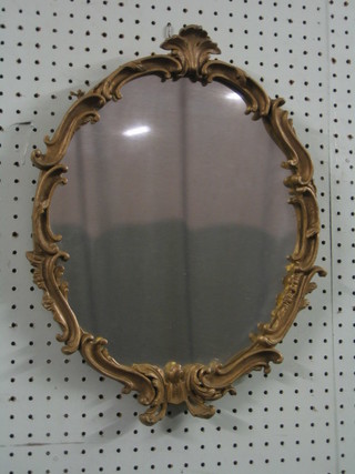 An oval plate wall mirror contained in a gilt frame 17"