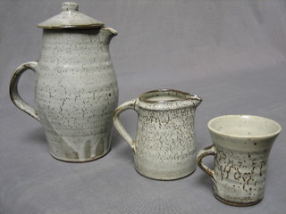 An 8 piece "Bernard Leach" coffee service: comprising circular coffee pot,  cream jug (chips to spout), 6 coffee cups (1 chipped) NB purchased by the Vendor at Bernard Leach's studio in the 1960's
