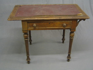 A Victorian mahogany side table with inset tooled leather writing surface, the base fitted a drawer, raised on turned and fluted supports (top loose and missing bracket to left hand side) 35"