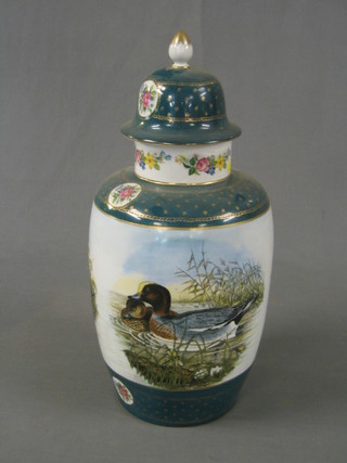 A modern porcelain urn and cover decorated ducks with green gilt and floral banding 20"
