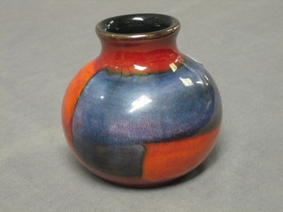 A circular red glazed Poole Pottery vase, the base marked Poole Pottery 4 1/2"