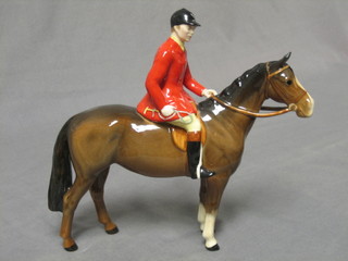 A Beswick  figure of a standing bay horse with huntsman, base marked Beswick  9"