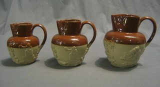 A set of 3 graduated stoneware harvest jugs decorated hunting scenes (largest with chip to rim)