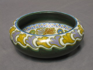 A circular Gouda green glazed bowl with stylised floral decoration, base marked 1838 Corqus Gouda Holland 8"