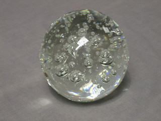 A circular clear glass bubble paperweight 4"