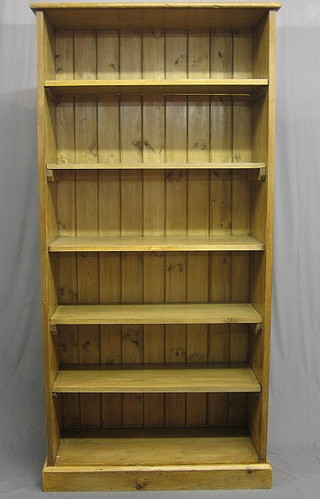 A 19th Century pine open bookcase fitted shelves, raised on a platform base 38"