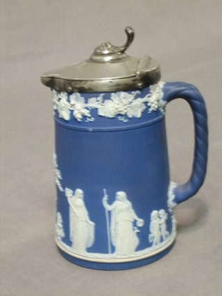 A Wedgwood blue Jasperware jug with pewter lid, the base marked Wedgwood Made in England 5 1/2"